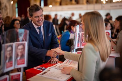 Stadtrat Peter Hanke schüttelt einer Kundin die Hand bei der Jobmesse Joboffensive 50+